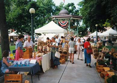 Oskaloosa residents enjoy an event in the town' revitalized downtown. Oskaloosa is one dozens of Iowa towns to have benefitted from the state's Main Street Program, helping advance rural livability. Photo: ##http://blog.preservationnation.org/category/general/main-street/page/2/## National Trust for Historic Preservation##