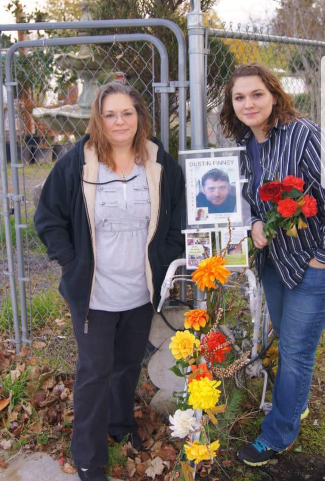 Kristi Finney, left, stands at a roadside memorial for her son Dustin, 28, who was killed while biking in Portland. Photo: Kristi Finney