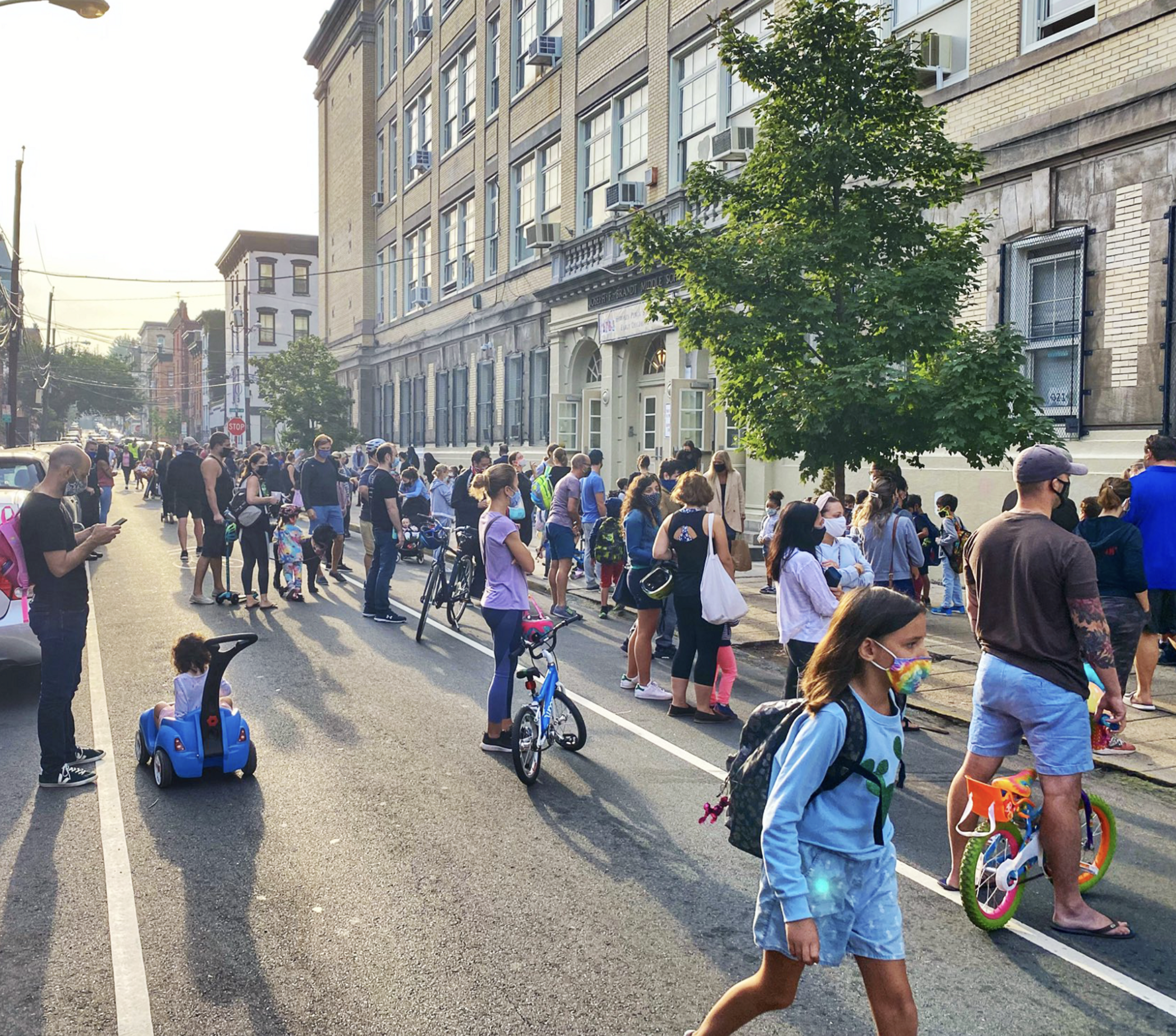 Families use the street to wait for their children to be released from school in Hoboken, N.J. Photo: Juan Melli