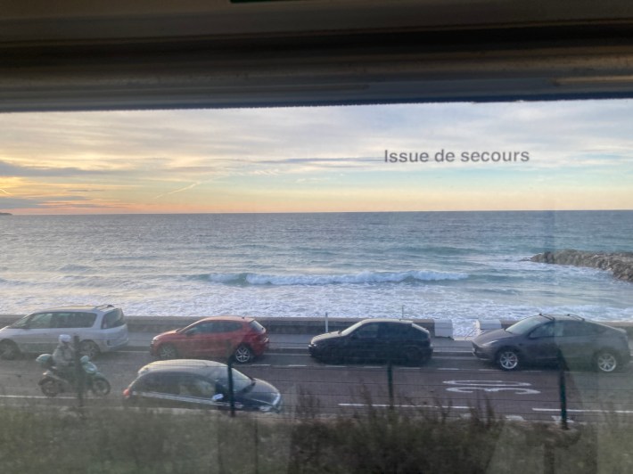 View from the corridor of the night train on the Mediterranean Sea 
